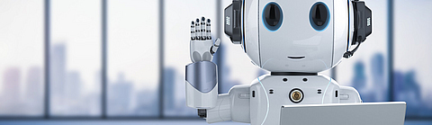 Lächelnder und winkender Roboter mit einem Laptop | © stock.adobe.com - phonlamaiphoto, generiert mit KI Lächelnder und winkender Roboter mit einem Laptop